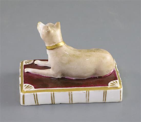 A Rockingham porcelain figure of a recumbent terrier, c.1830, L. 9.7cm